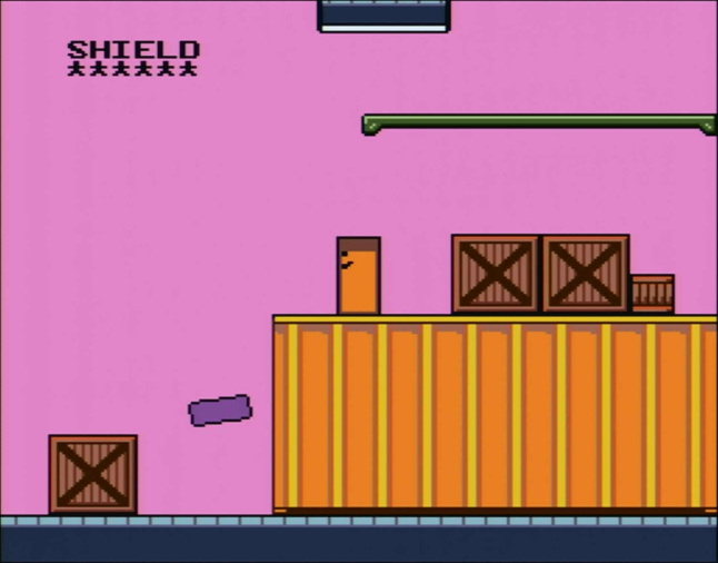 An orange rectangle standing on a shipping container